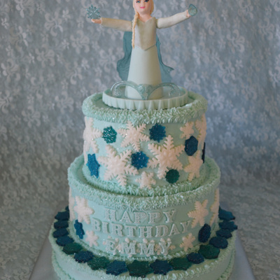 Frozen Themed Cake With Gumpaste Elsa Cake Topper Rolled Buttercream White Snowflakes And Hard Candy Blue Snowflakes I Decorated With All