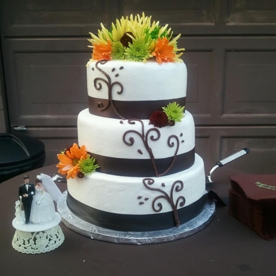 Brown And White Wedding Cake With Fresh Flowers