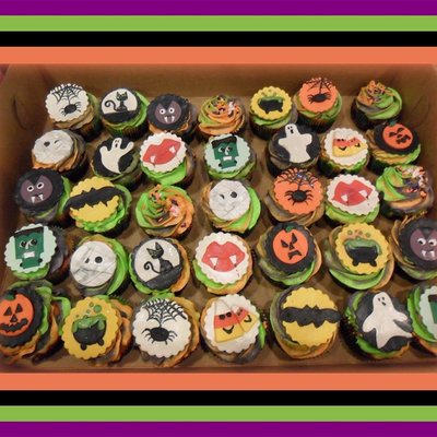 Halloween Cupcakes Orange Green And Purple Batter And Buttercream Frosting With Halloween Themed Fondant Plaque Toppers