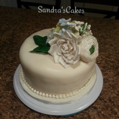 Chocolate Cake Covered In Off White Fondantgumpaste Hydrangeas Peony Blossoms Roses Leaves And Buds Pearl Border