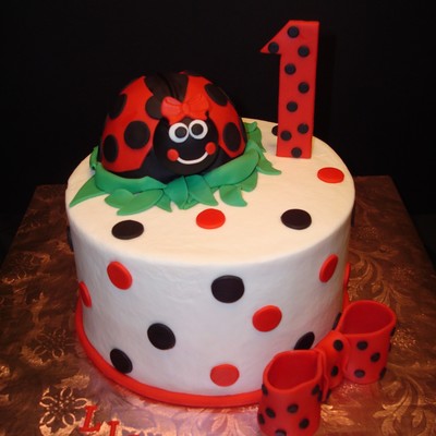 Lily Bug Cake For A 1St Birthday Girl Name Lily Iced In Buttercream With All Fondant Decorations The Lily Bug Is Cake Covered And Decorate...