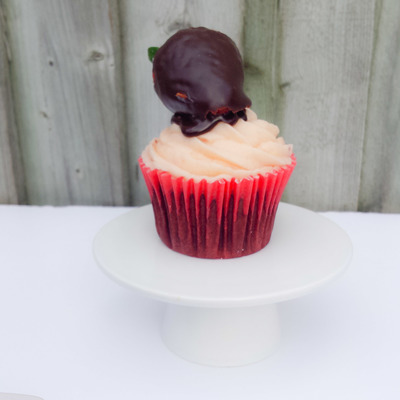 Chocolate Cake Frosted With Strawberry Buttercream Drizzled With Dark Chocolate Ganache And Topped With A Chocolate Covered Strawberry