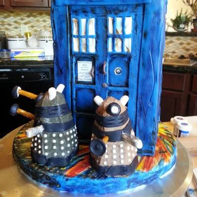 Battle Worn Tardis Fights The Daleks Chocolate Cake Covered In Modeling Chocolate With Mini Cupcake Daleks