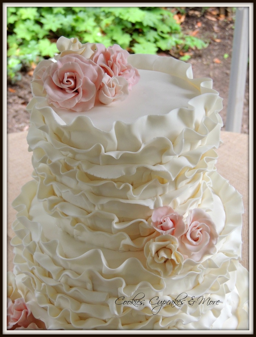Ivory Wedding Cake With Fondant Ruffles And Pink Gum Paste Roses