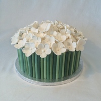 Spring Cake Cake with flowers and stems, both made out of modeling paste.