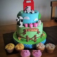 Tizi Farm Cake Two tier cake, with a very cool cow and a farm animals cupcakes