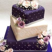 Purple And Cream Wedding Cake With Roses A 3 tier square wedding cake with gumpaste roses, stencilling and quilting.