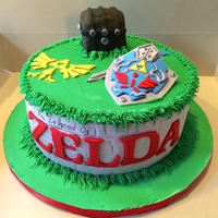 Legend Of Zelda Cake Chocolate cake with buttercream filling. Fondant covering, treasure chest is rice krispies, lettering and symbols are fondant/ gum paste.