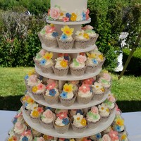 Summer Floral Wedding Cupcake Tower 200 cupcakes/fondant covered cake with handmade sugar flowers to match the floral pattern on the bridesmaids dresses.