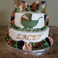 Camo Baby Shower Cake This is a buttercream cake with fondnt bow, carriage, and ruffles.