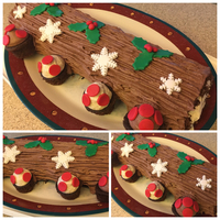Buche De Noel Chocolate sponge cake filled with eggnog buttercream. Fondan accents. Mini cupcakes for mushrooms.