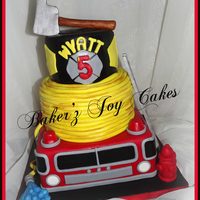 Firetruck Cake Firetruck cake in 2 different flavors. Marble bottom and middle tier and Mint Chocolate chip top tier. All edible. Handmade ladder, axe,...