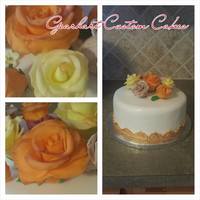 Fall Roses Gum paste roses were highlighted with luster dust. The border around the cake was painted gold to stand out against the white fondant.