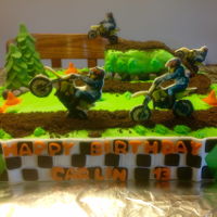 Crazy For His Dirtbike ! 12x13 inch cake, covered in buttercream frosting. Chocolate graham cracker (dirt) fondant rocks, trees and caution cones. The dirt bike...