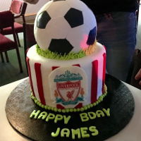 Liverpool Football Birthday Cake liverpool footaball birthday cake.fondant covered cake with red stripes, edible wafer paper with liverpool logo on a white choc plaque....
