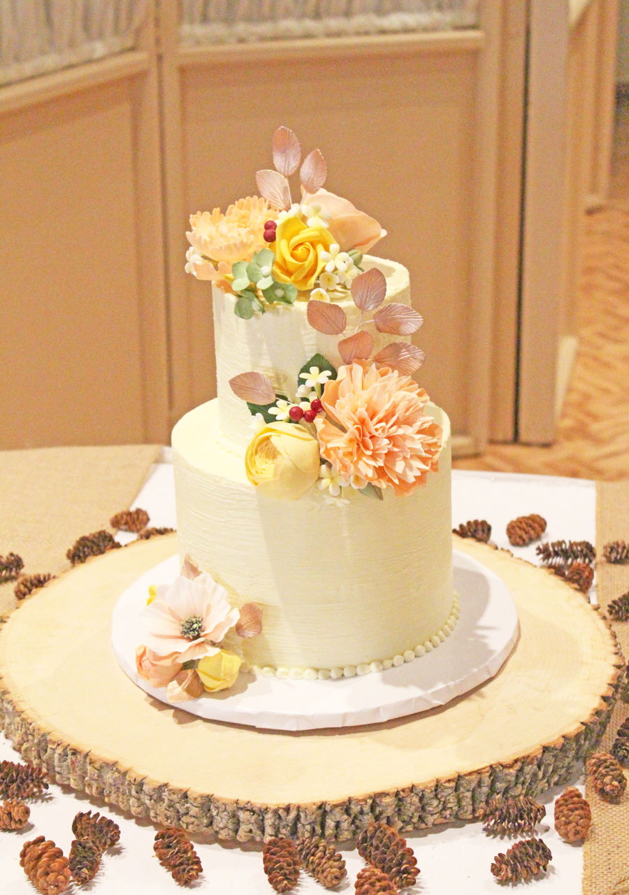 Two Tiers With A Textured Buttercream Covered In Variety Of Sugar Flowers Two Tiers With A Textured Buttercream Covered In Variety Of Sugar Flowers
