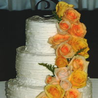 Yellow Rose Cascade White rustic buttercream featuring a fresh yellow rose cascade
