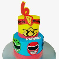 Power Rangers Power rangers cakes with fondant faces on the bottom tier.