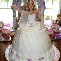 Princess And Her Castle cakes are covered in buttercream with royal icing flowers.