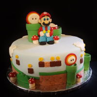 Super Mario Cake 10" M&M confetti cake with fondant Mario figure and accessory pieces.