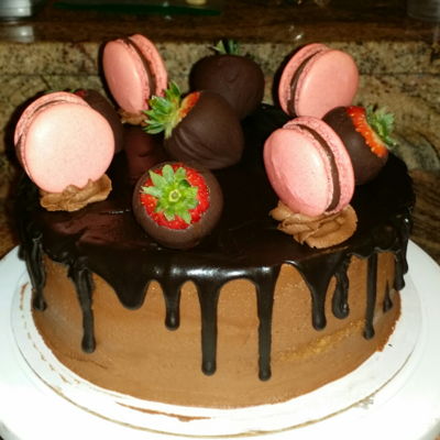 Drip Cake With Homemade Macaroons And Chocolate Covered Strawberries.