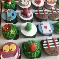 Alice In Wonderland Made these cupcakes for an Alice in Wonderland themed baby shower along with a small cake.