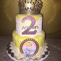 Disney Princess Cinderella Cake Disney Princess Cinderella cake in vibrant yellow quilted fondant. Gold crown topper and edible lace that makes this cake delicate and...
