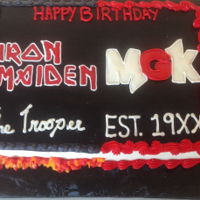 Iron Maiden/mgk Split Cake 9x13 half Iron Maiden and MGK cake. Iced in Buttercream frosting. Decorated in Buttercream frosting.