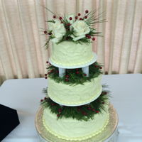 Winter Wedding Cake This is a vanilla cake with whipped white chocolate ganache icing and winter floral decoration.