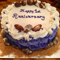 Happy Anniversary Three-layer marble cake with buttercream frosting. Decorated with milk chocolate hazelnut seashells.