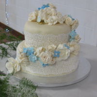 Ivory Roses Wedding Cake I made this cake for my nephew and his new wife. I made and covered both tiers and the sugar flowers at my home home, then It was...