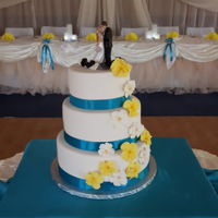 Blue And Yellow Wedding Cake Fondant covered buttercream cake. Gumpaste flowers and snowboards.