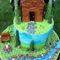 Cabin In The Woods For my mom's 70th birthday. She wanted a cake with a creek and her sitting by it. They live in a cabin, so went with a cabin as well....