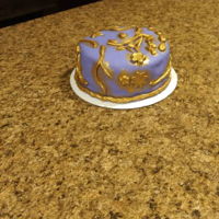 An Elegant Birthday Cake For An Elegant Lady This is a multicolored, vanilla cake under purple Fondarific fondant with gold accents. I made it for a friend's birthday! Its a...