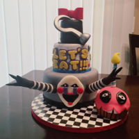 Five Nights At Freddy's Cake was made for my nephew. Figures and items were made with fondant, gum paste, and RKT.
