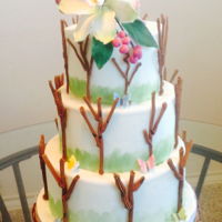 Simple Tree Wedding Cake Three tier tree wedding cake. The trees are made from royal icing and cake decorated Cymbidium Orchid flowers.