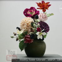 Flower Arrangement This arrangement is a mix of gum paste and cold porcelain flowers, thought with the way the small things like calixes fall off when...