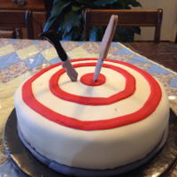 On Target These knives are right On Target embedded in this rich marble cake covered in buttercream and fondant.