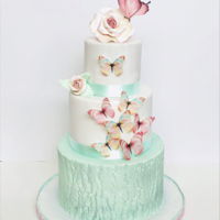 Butterflies And Roses Three teir cake: dark chocolate and raspberry filling, lemon sponge with a vegan lemon curd, And a milk chocolate cake filled with a...