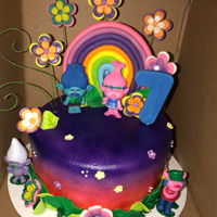 Trolls Cake This is an airbrushed trolls cake. The flowers, number, leaves and rainbow are made of fondant. The characters are plastic cake toppers