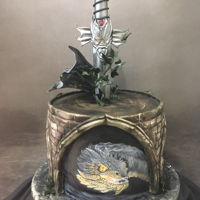 Hand Painted Dragon Cake Handpainted dragon scene with gumpaste sword and daisy paste dragon wing