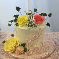 Oh Baby Moist white 4 layer Baby Shower cake covered in vanilla/almond buttercream. The cake was decorated with fondant flowers and Royal Icing...
