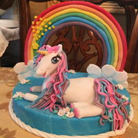 Unicorn, Rainbow And Shooting Star Cake Topper Rainbow made of gumpaste and let dry. Covered 8&rdquo; foam round with blue gum paste. Pressed rainbow into base before it dried to...