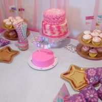 Pink Birthday Vanilla cake, with buttercream. Splatter "paint" bottom with rosette top.