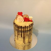 Sunshine And Roses Red velvet cake with lemon ganache, cake pops, fondant roses, and cherry chocolate drips.