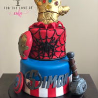 Avengers Cake 2 tier fondant cake with molded rice crispy and fondant gauntlet.