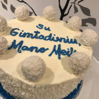 Rafaello Cake Topped wuth Rafaello and toasted shredded coconut with rafaello filiing and frosted with coconut frosting.