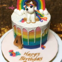 Rainbow Unicorn Cake Buttercream with candy drip. Fondant unicorn and rainbow.