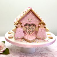 Valentine Valentine cookie house, all cookies decorated with royal icing. Fondant covered cake board, sprinkles