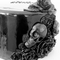 Black Skull Goth Cake Shiny black fondant cake with skulls and molded flowers
